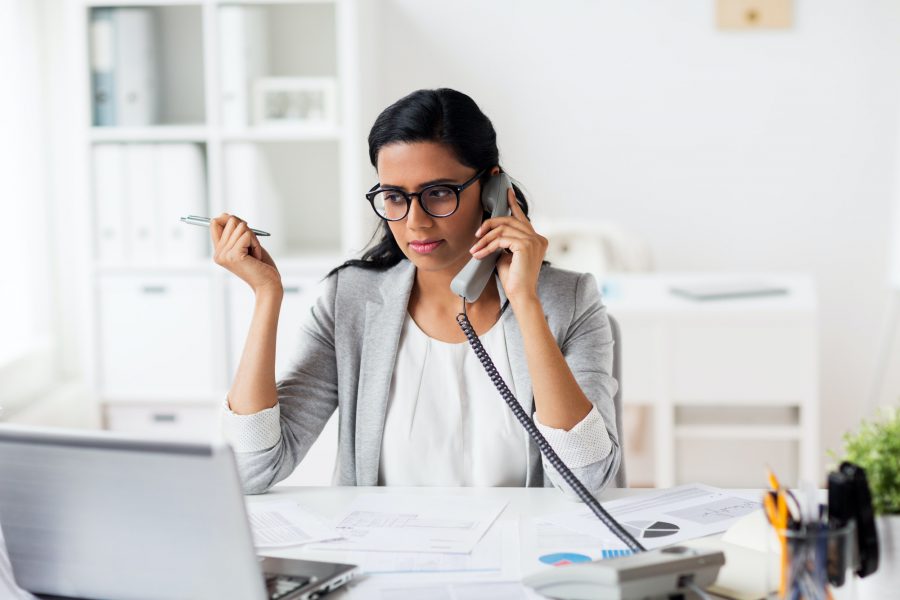 businesswoman calling on phone at office